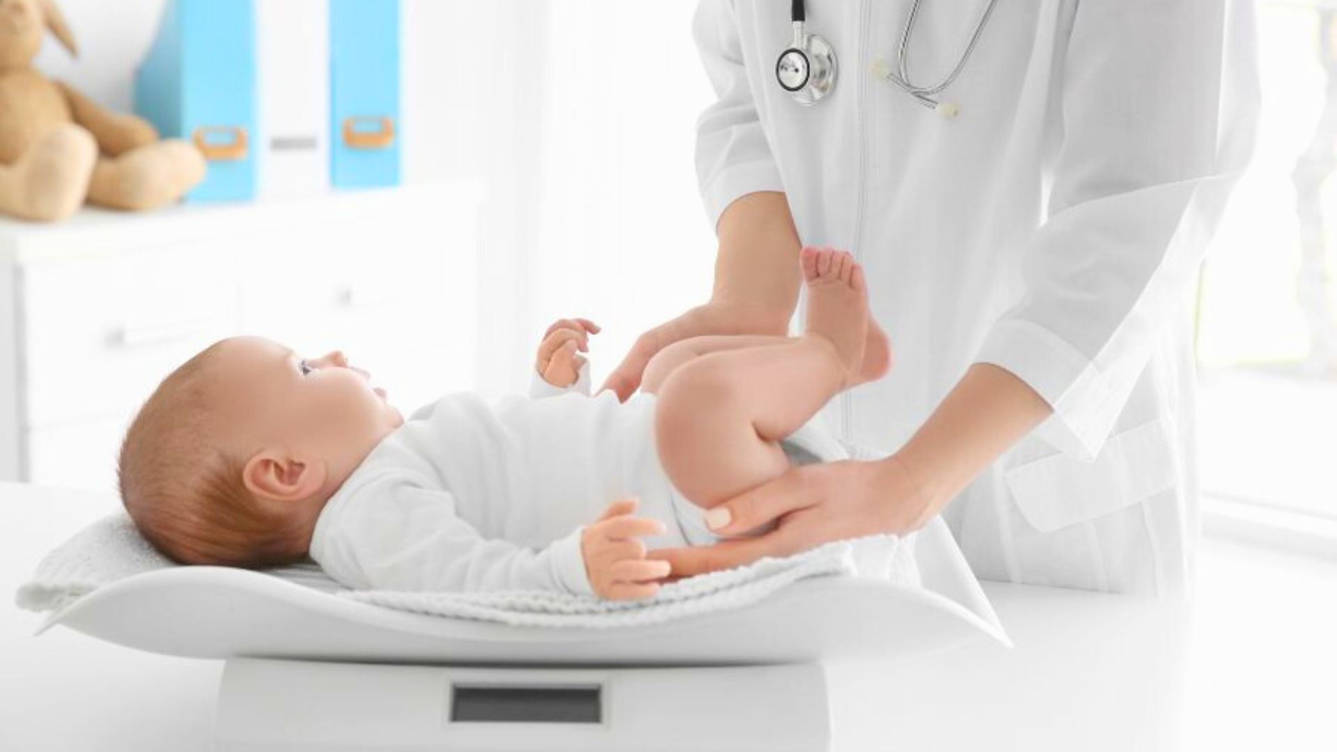 Newborn baby being examined by a doctor on a scale, representing a 9-pound baby at birth