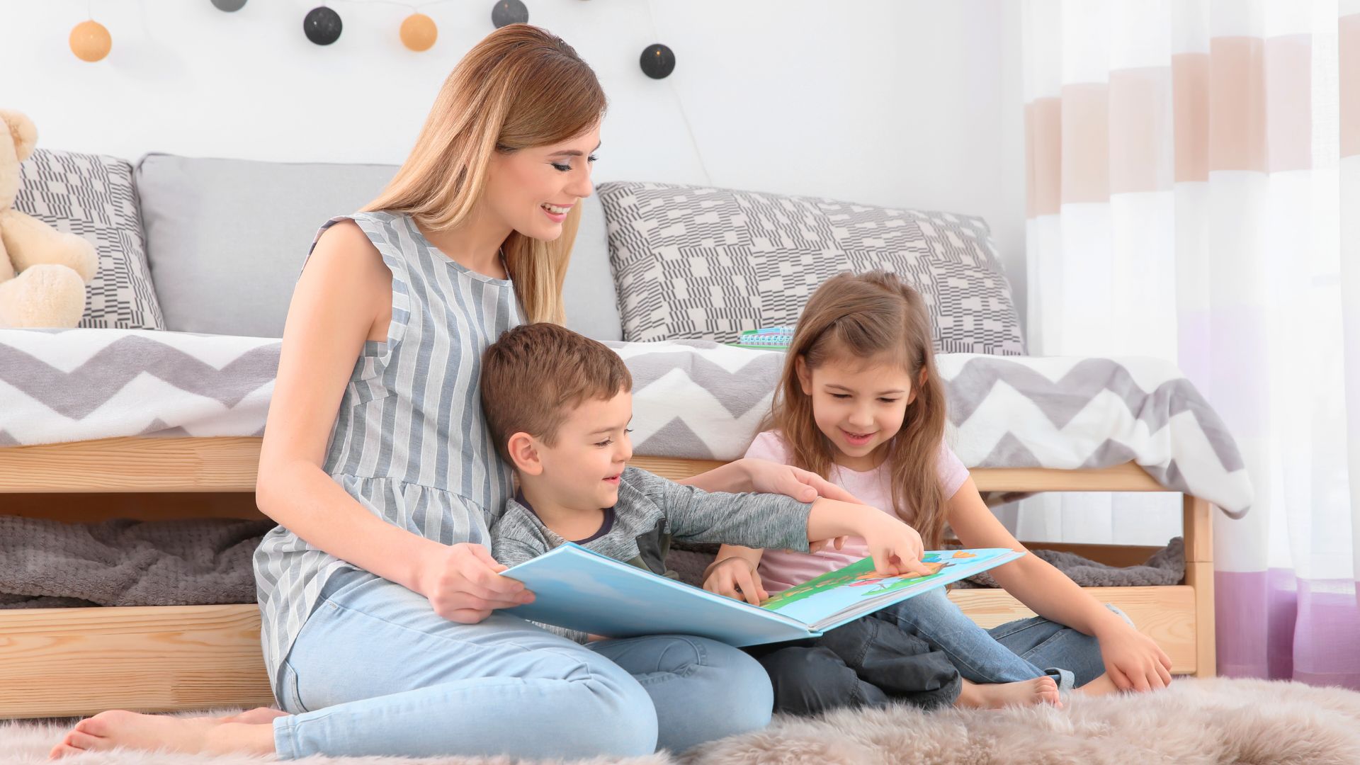 Vacation nanny reading a book with two young children, providing childcare support during a family holiday